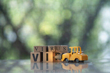Toy drill car kill to VIRUS text in wooden blocks. Beat virus concept.