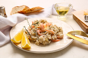 Plate with tasty risotto on light background