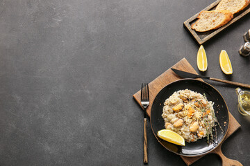 Plate with tasty risotto on dark background