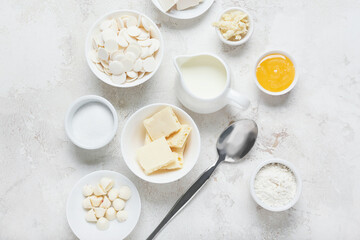Chocolate drops and ingredients for bakery on light background