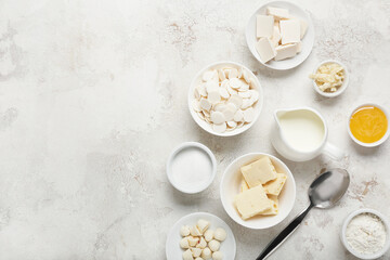 Chocolate drops and ingredients for bakery on light background