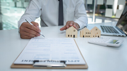Real estate agent and customer signing contract to buy house, insurance or loan real estate.rent a house,get insurance or loan real estate or property.