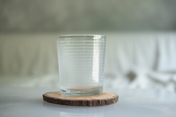 A empty clear glass water on wooden saucer