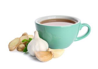 Cup of healthy garlic tea on white background