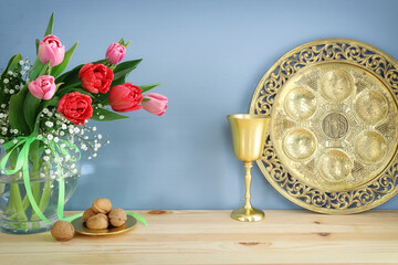 Pesah celebration concept (jewish Passover holiday). Traditional pesah plate text in hebrew: Passover, horseradish, celery, egg, bone, maror, sweet dates jam