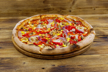Delicious fresh pizza on a wooden table