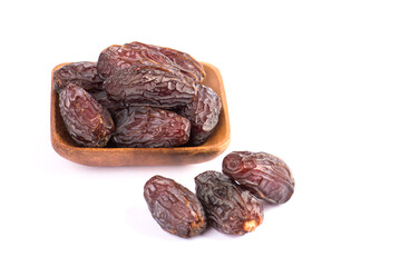 HURMA, Dates. Dried dates fruit with wooden plate on white background. Popular fruit of Ramadan. .