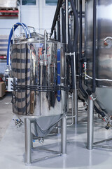 Vertical background image of steel tanks at industrial brewery workshop, copy space