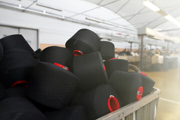 Close-up of the produced threads against the background of the production line. Factory for the...