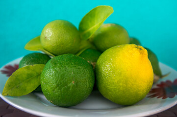 Fresh green eco Lime fruits with green leaf on the plate.