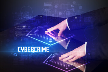 Hand touching digital table with CYBERCRIME inscription, new age security concept
