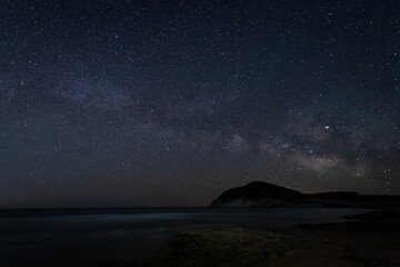 Fototapeta na wymiar Night landscape with milky way from Genoveses beach. Natural Park Cabo de Gata. Andalusia. Spain.