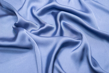 Blue silk or satin luxury fabric texture. Top view.