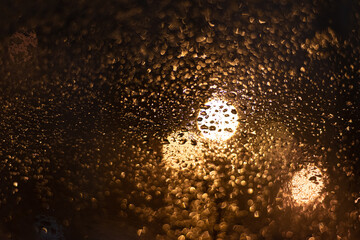 Blurred background with raindrops and lights.