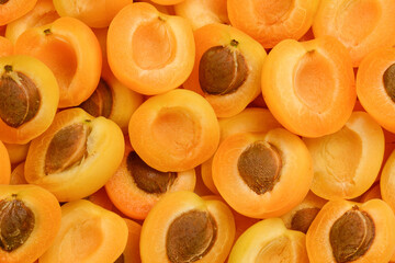 Ripe juicy orange apricots slices fruit background.