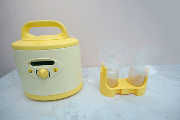 At the room for breast milk taking: electric milk pump placed on a table