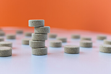 selective focus photo of DGL (licorice root extract) chewable tablets. dietary concept: tower of DGL tablets. dietary supplement topview
