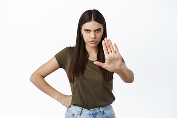 Stop, I said no. Angry frowning woman stretch out hand in block gesture, prohibit something bad,...