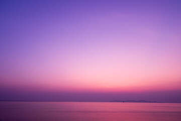 Twilight sunrise sky over tropical sea and beach in Thailand. Purple filtered