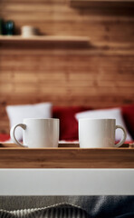 Fototapeta na wymiar two white glasses on a wooden breakfast stand