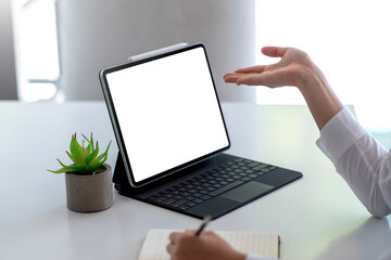 Mock up. Woman using tablet white blank screen table at office.