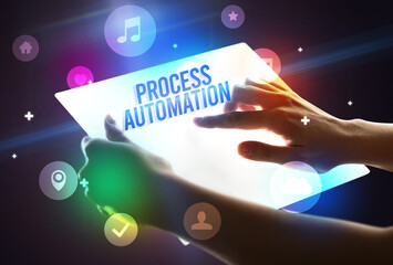 Holding futuristic tablet with PROCESS AUTOMATION inscription, new technology concept