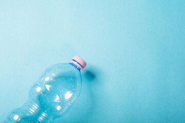 Plastic bottles crushed on the blue background. Recycling concept