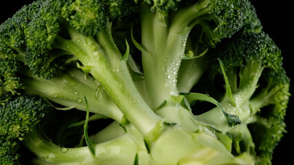 fresh broccoli close up on black background. Vegetables for heathy life