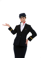 Obraz na płótnie Canvas Beautiful young flight attendant standing and pointing towards something isolated on white background
