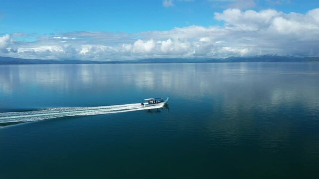 Following a boat aerial view of golfo dulce Costa Rica glassy water