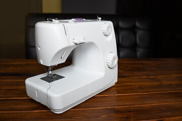 Sewing machine on table in tailor's workshop