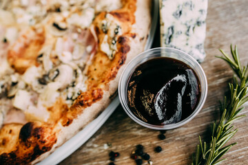 Large pizza with ham and porcini mushrooms. Pizza ingredients. pizza with rosemary sprigs and sauce