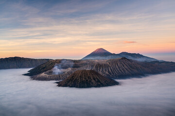Beautiful sunrise at Bromo volcano mountain in East Java, Indonesia surrounded by morning fog.