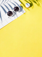 Summer yellow cosmetics flat lay with sunglasses . Top view beauty composition. Copy space	