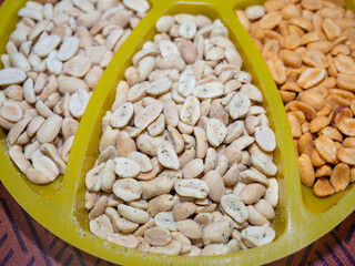 salted peanuts with different flavors on the table in a bowl. beer snack