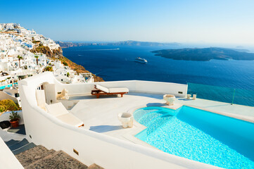 White architecture on Santorini island, Greece. Luxury swimming pool with sea view. Famous travel destination
