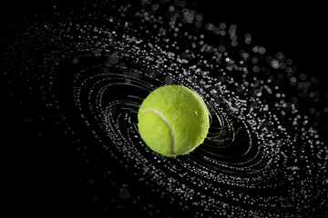 Water splashes from a spinning tennis ball - obrazy, fototapety, plakaty