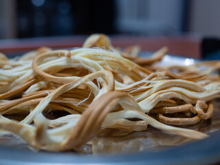 pigtail cheese on a plate. beer appetizer
