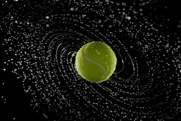 Water splashes from a spinning tennis ball
