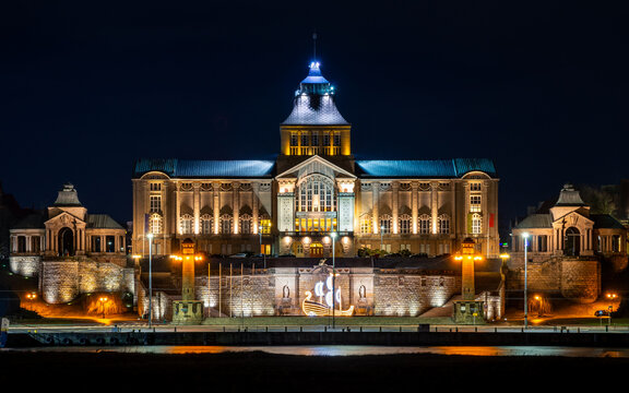 night view of an illuminated old building by the river