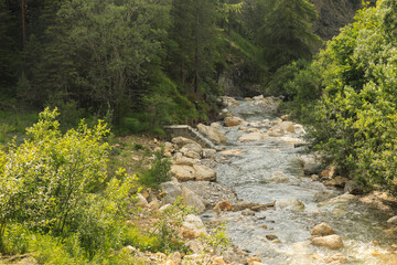 Mountain river with waterfalls, San Cassiano village, South Tyrol, Italy