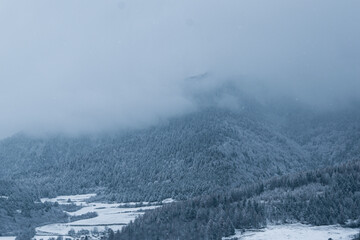 Snowy mountain covered in clouds in winter
