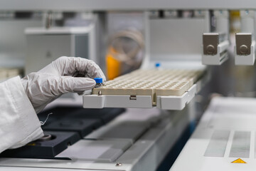 Hands handing laboratory equipment