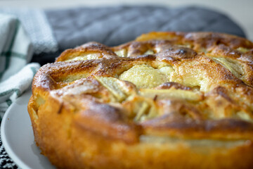 Gros plan sur un clafoutis aux poires bien dorée sortant du four