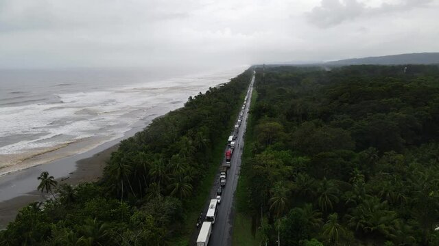 Road crossing a jungle along the caribbean sea traffic jam aerial rainy day Costa Rica Limon puerto viejo