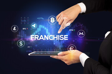 Close-up of a touchscreen with FRANCHISE inscription, business opportunity concept