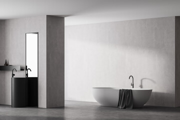 Obraz na płótnie Canvas Modern bathroom interior with white bathtub and marble sink with rectangle vertical mirror, in eco minimalist style with concrete floor and walls. No people. 3D Rendering