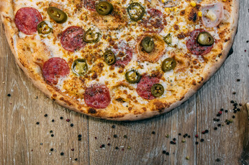 pizza with bacon, salami and vegetables
