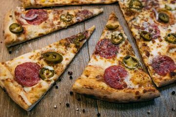 Pizza slices pepperoni with salami and paprika