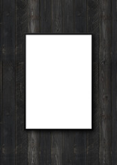 Black picture frame hanging on a black wooden wall